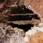 Two deteriorated 4x4 beams were found on the surface of the well.