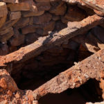 The upper portion of the well was likely torn down when it was covered.