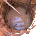 Draining the well of debris.