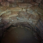 Made of stacked, shaped sandstone blocks.