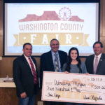 Commissioners presenting prize money to Adriana Morgan Fair Logo Contest 2019 Winner
